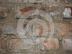 Ruined red brick wall textred brick, wall macro fragment. Fragment of an old brick wall. Horizontal orientation, selective focus