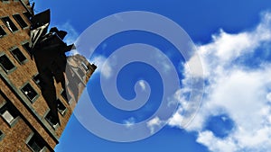 Ruined residential building against blue sky