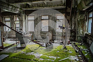 Ruined room covered in moss at the abandoned building located in the Chernobyl ghost town