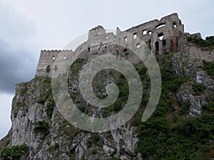 The ruined ruins of Beckov Castle stand on a steep 50 m high cliff in the village of Beckov near the river VÃ¡h