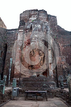 The ruined standing Buddha statue