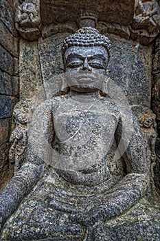 Ruined statue in heritage Buddhist excavated site Ratnagiri meaning hill