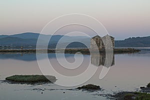 Ruined stone house and reflection