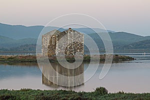 Ruined stone house and reflection