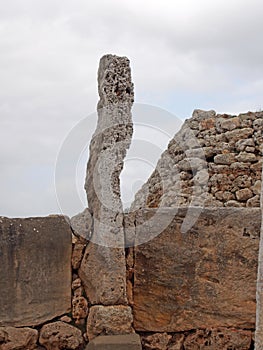 Ruined village of Trepuco Minorca Balearic Islands showing a large megalith and taula in the background