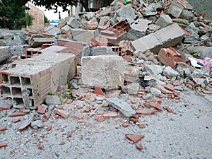 A ruined wall at the edge of the road