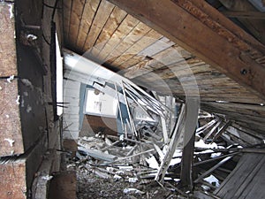 Ruined wooden building. The collapsed roof of a wooden house. Abandoned building.