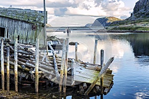 Ruined wooden house on the shore of a beautiful sea in a mountain landscape