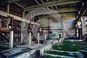 Ruins of abandoned industrial factory, large warehouse or hangar building with rusty equipment and machine tools