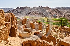 Ruins of the abandoned mud brick city Kharanaq near the ancient city Yazd in Iran photo