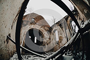 Ruins of an abandoned old church in the melancholic cold field