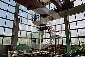 Ruins of abandoned polluted industrial factory room, abandoned industrial building after war