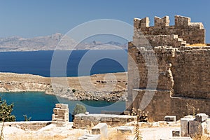 Ruins of the Acropolis of Lindos with the St. Paul`s Bay in the background