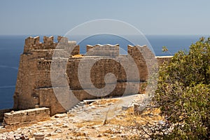 Ruins of the Acropolis of Lindos with the St. Paul`s Bay in the background