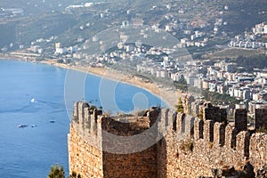 The ruins of the Alanya Castle against the backdrop of the sandy Cleopatra Beach and the coastal part of the city. Turkey