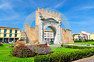 Ruins of ancient brick wall and stone gate Arch of Augustus Arco di Augusto in Rimini