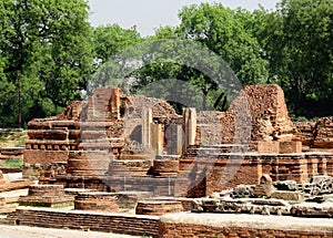 Ruins of ancient buildings, temple and Buddhist stupas of the ancient city of Sarnath, near Benares, India photo