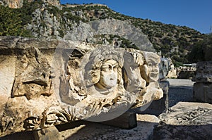 Ruins of ancient city of Myra in Demre, Turkey. Theatrical mask stone relief of ancient town of Myra