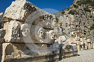 Ruins of ancient city of Myra in Demre, Turkey. Theatrical masks and faces relief and ancient rock tombs