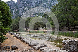 Ruins of the ancient city of Olympos in Cirali village in Antalya, Turkey. Local and foreign tourists come to visit the ancient ci