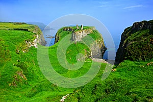Ruins of Dunseverick Castle atop green cliffs of the Causeway Coast, Northern Ireland photo