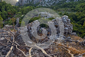 ruins of an ancient fortress in the green mountains. The ancient city of Olympos