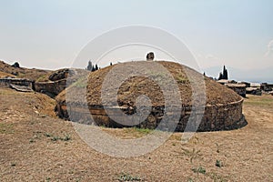 The ruins of the ancient Hierapolis city next to the travertine pools of Pamukkale, Turkey. Tumulus.