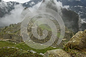 Ruins of the ancient Inca city machu picchu in fog, Peru