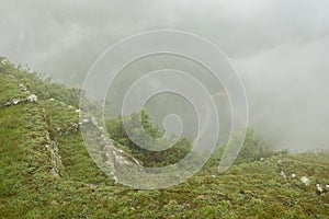 Ruins of the ancient Inca city machu picchu in fog, Peru