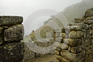 Ruins of the ancient Inca city machu picchu in fog, Peru