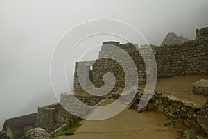 Ruins of the ancient Inca city machu picchu in fog, Peru