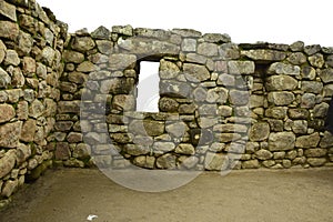 Ruins of the ancient Inca city machu picchu in fog, Peru