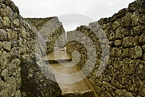 Ruins of the ancient Inca city machu picchu in fog, Peru