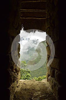 Ruins of the ancient Inca city machu picchu in fog, Peru