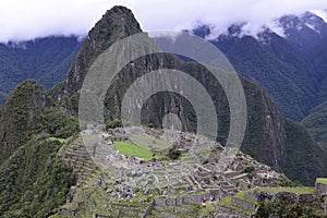 Ruins of the ancient Inca city machu picchu in fog, Peru