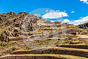 Ruins of ancient Incan citadel with terraces on the mountain, Pisac, Peru