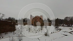 Ruins of Ancient Livonian Order`s Stone Medieval Castle Latvia Aerial Drone Top Shot From Above. Restored Castle Capella at Winter