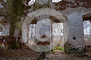 The ruins of an ancient red brick church with remnants of white plaster