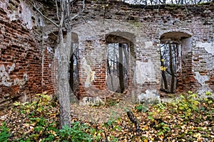 The ruins of an ancient red brick church with remnants of white plaster