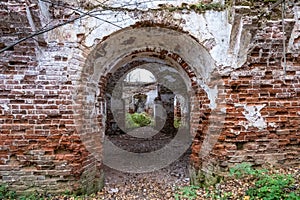 The ruins of an ancient red brick church with remnants of white plaster