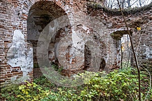 The ruins of an ancient red brick church with remnants of white plaster