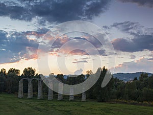 Ruins of an ancient roman aqueduct at sunset
