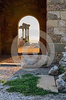 Ruins of ancient Temple of Apollo in Side on sunset in arch, Alanya province, Turkey. Ruined old city. Unesco Cultural