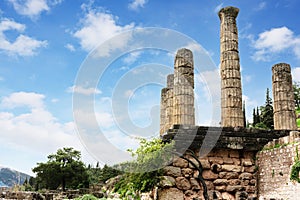 Ruins of an ancient temple, Temple Of Apollo At Delphi Oracle, Greece, ncient greek columns against blue sky photo