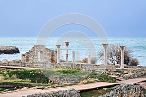 Ruins of antique greek temple with columns on the seashore in Chersonesos