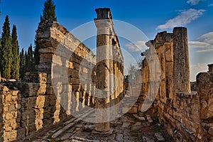 Ruins of Appollo temple with fortress at back in ancient Corinth, Peloponnese, Greece