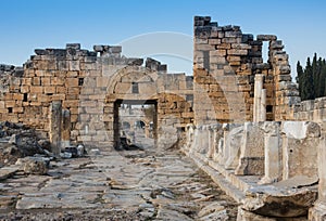 Ruins of Appollo temple with fortress at back in ancient Corinth, Peloponnese, Greece