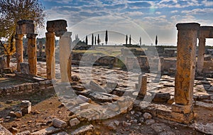 Ruins of Appollo temple with fortress at back in ancient Corinth, Peloponnese, Greece