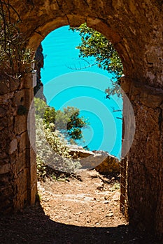 Ruins arch gate entrance of old fortress in Assos on Kefalonia island in Greece