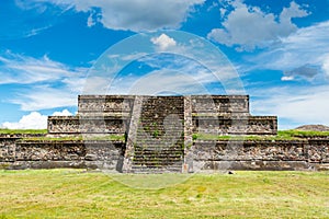 Ruins of the architecturally significant Mesoamerican pyramids and green grassland located at at Teotihuacan, an ancient